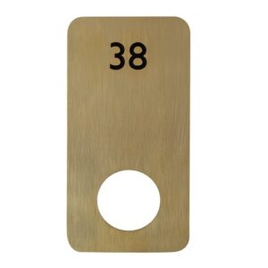A brass locker number plate with a black number 38 on top and a circular cut out at the bottom for locker doors.