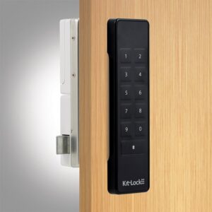 A gloss black kl1100 keypad locker lock fitted to a wooden door with a cam bar on show.