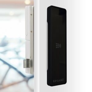 A gloss black kl1100 rfid locker lock on a white locker door showing the cam bar and how it works.