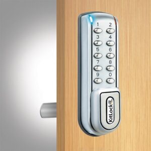 A silver kl1200 electronic locker lock fitted to a wooden locker door.