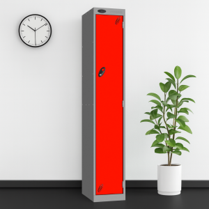 A red and silver probe 1 door steel locker in a room setting with a white wall, black floor, a plant and a wall clock.
