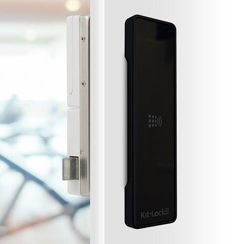 A gloss black kl1100 rfid locker lock on a white locker door showing the cam bar and how it works.