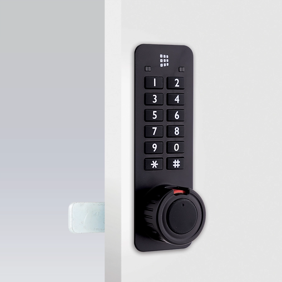 A black codelocks KL90 electronic combination lock in the vertical position on a white door.